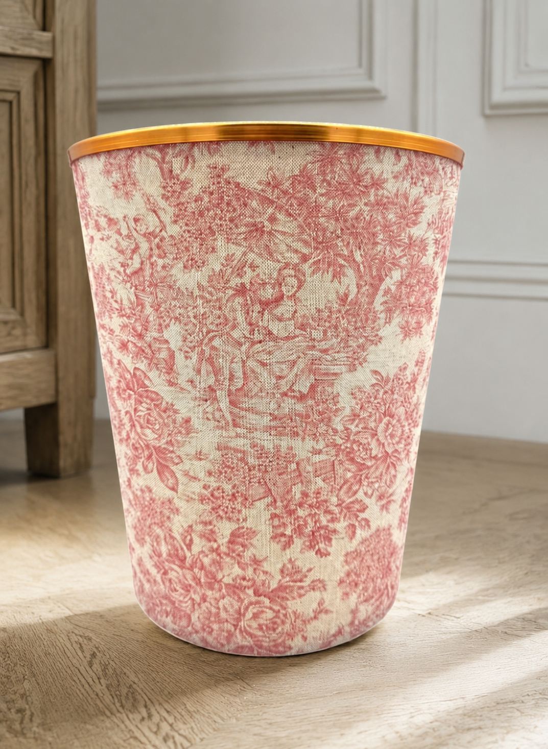 Pink toile handmade waste paper bin with a gold trim in a refined country-estate interior